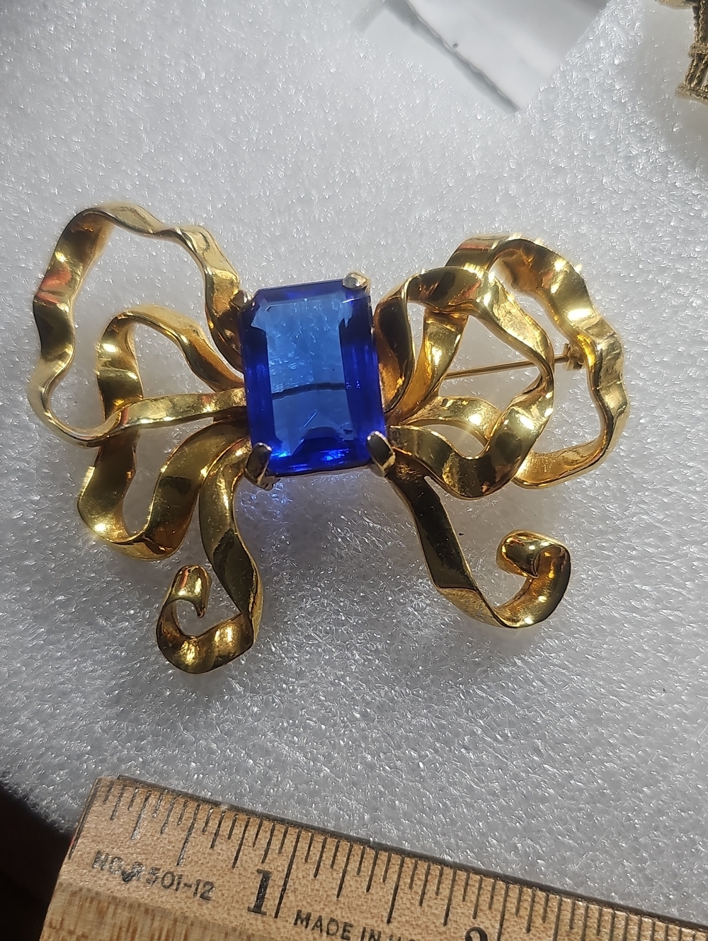 Gold Bow Brooch with Deep Blue Gemstone